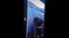 Wife pranks husband by pushing water off the gazebo roof onto his head.