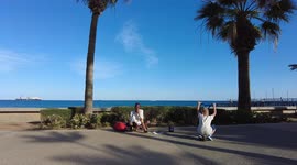 An African plays the trumpet on the embankment of the city of Limassol, Cyprus.