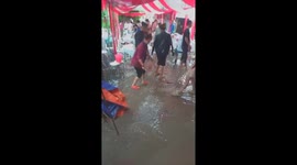 Diners help the bride and groom clean up floodwaters when floodwaters flood their wedding