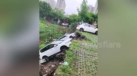 Road collapses causing damage to parked vehicles in southern China