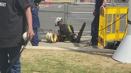 Police officers climb down a manhole in Parliament Square, London