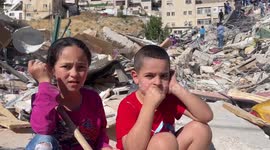 Palestinian family inspect rubble after Israeli authorities bulldoze house