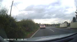 An insane driver overtakes at a T junction, into on coming traffic