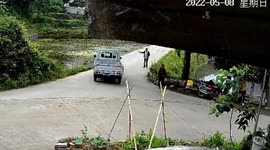 Truck in China knocks over pedestrian before driving off road into river