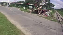 Motorcycle rider clotheslined after trying to beat level-crossing barrier