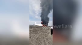 Plane skids off runway and catches fire in China