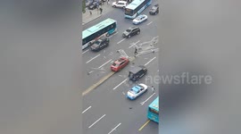 Students clear scattered barriers after car crashes into central reservation in China