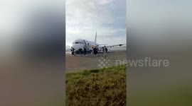 Passengers quickly evacuate plane after fire erupts during takeoff in southern China