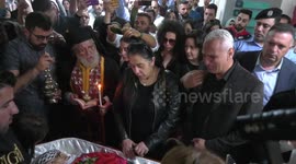 Colleagues and friends react as Palestinian flag-draped body of Shireen Abu Akleh arrives at Ramallah hospital