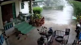 Motorcycle rolls out of driveway when powerful summer storm hits