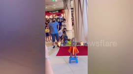 Monkey forced to do tricks to entertain shoppers in Thailand