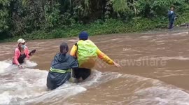 Teachers cross raging river to take vote machines to remote village in the Philippines