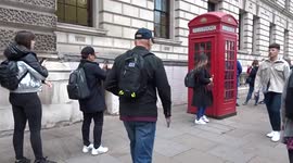 Tourists queue for selfies with iconic red telephone box in central London