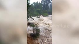 Raging torrents of water cascade over rocks following heavy rain in southern Thailand