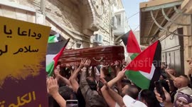 Mourners carry slain Al Jazeera journalist Shireen Abu Akleh during funeral procession