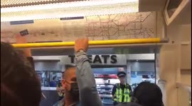Fans singing and cheering on the the tube on the way to the Chelsea vs Liverpool FA Cup Final game at Wembley
