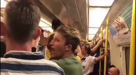 Football fans singing and cheering on the the tube on the way to the Chelsea vs Liverpool FA Cup Final game at Wembley
