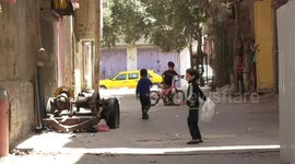Palestinian children play near their house between the alleys of Al-Bureij refugee camp on the 74th anniversary of the Nakba