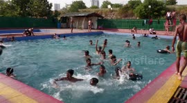 Delhi residents flock to pool as soaring temperatures set new record high