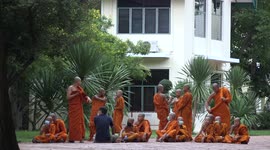 Young novice Buddhist monks attending instruction class at a Thai temple grounds.