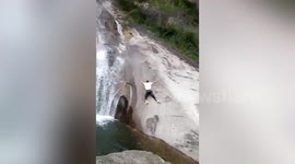 Dramatic moment man falls down waterfall after attempting to run across it