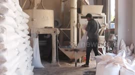 Palestinian labourers work in a traditional wheat mill in Gaza city