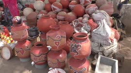 Indian woman selling clay water pots on roadside shop during summer season in Rajasthan