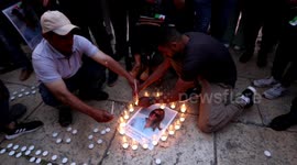 Palestinians light candles for Shireen Abu Akleh at Church of the Nativity in Bethlehem on Monday