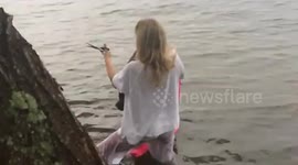Woman helps blue heron