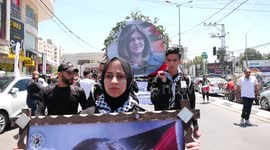 Palestinian scout carry a mock coffin as they hold a symbolic funeral for slain Al Jazeera journalist Shireen Abu Akleh