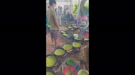 Ten chefs make thousands of Vietnamese pancakes, with each person cooking 10 pans during a festival in western Vietnam