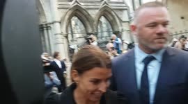 Coleen Rooney smiles as she and husband Wayne depart court on Day 6 of 'Wagatha Christie' libel trial