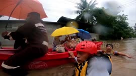 Rescue teams wade through flooded roads to save stranded residents in Thailand