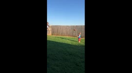 Father and son playing catch with American football ends in whack to the face