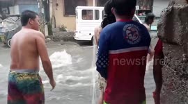 Sudden rainstorm floods riverside neighbourhood in the Philippines