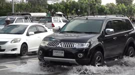 Drivers battled through flooded road after heavy rain in Bangkok, Thailand
