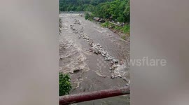 Stranded youngster jumps across rocks to escape flooded river in the Philippines