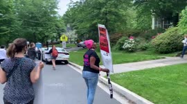 A pro-choice protester shouts, “What do we want? Abortion rights!” outside Supreme Court Chief Justice John Roberts’ house..