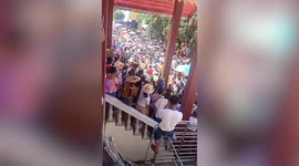 Devotees push giant Buddha statue during religious procession