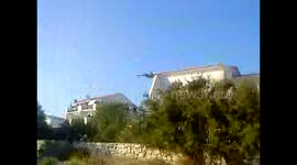 Plane flying inches above the house on sea