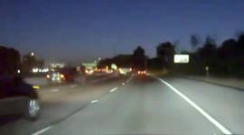 Cyclist rides tall bike down middle of US freeway