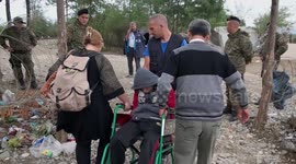 Exhausted Syrian boy taken across border in wheelchair