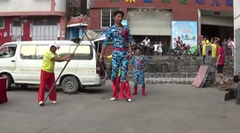 Man performs balance stunts of swinging on rope