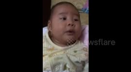 Cute baby learns to whistle with his dad