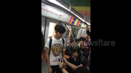 Man bursts into tears after boyfriend proposes on Beijing Tube
