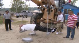70-year-old man with his chest crushing stone and striking trunk