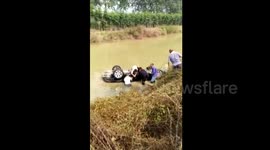 villagers save a car from river