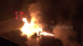 Firefighter putting out car fire