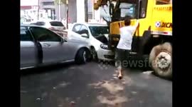 Crane crushes six cars after driver faints