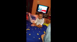 Cute baby can't stop laughing at mum's foot
